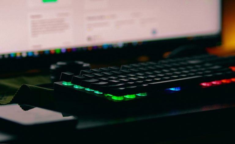 A computer keyboard with neon lights.
