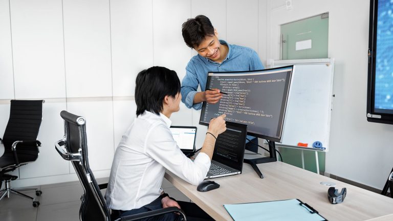Engineers reviewing code on a monitor: A Practical Guide to Assessing a Public-Record API Before You Integrate It