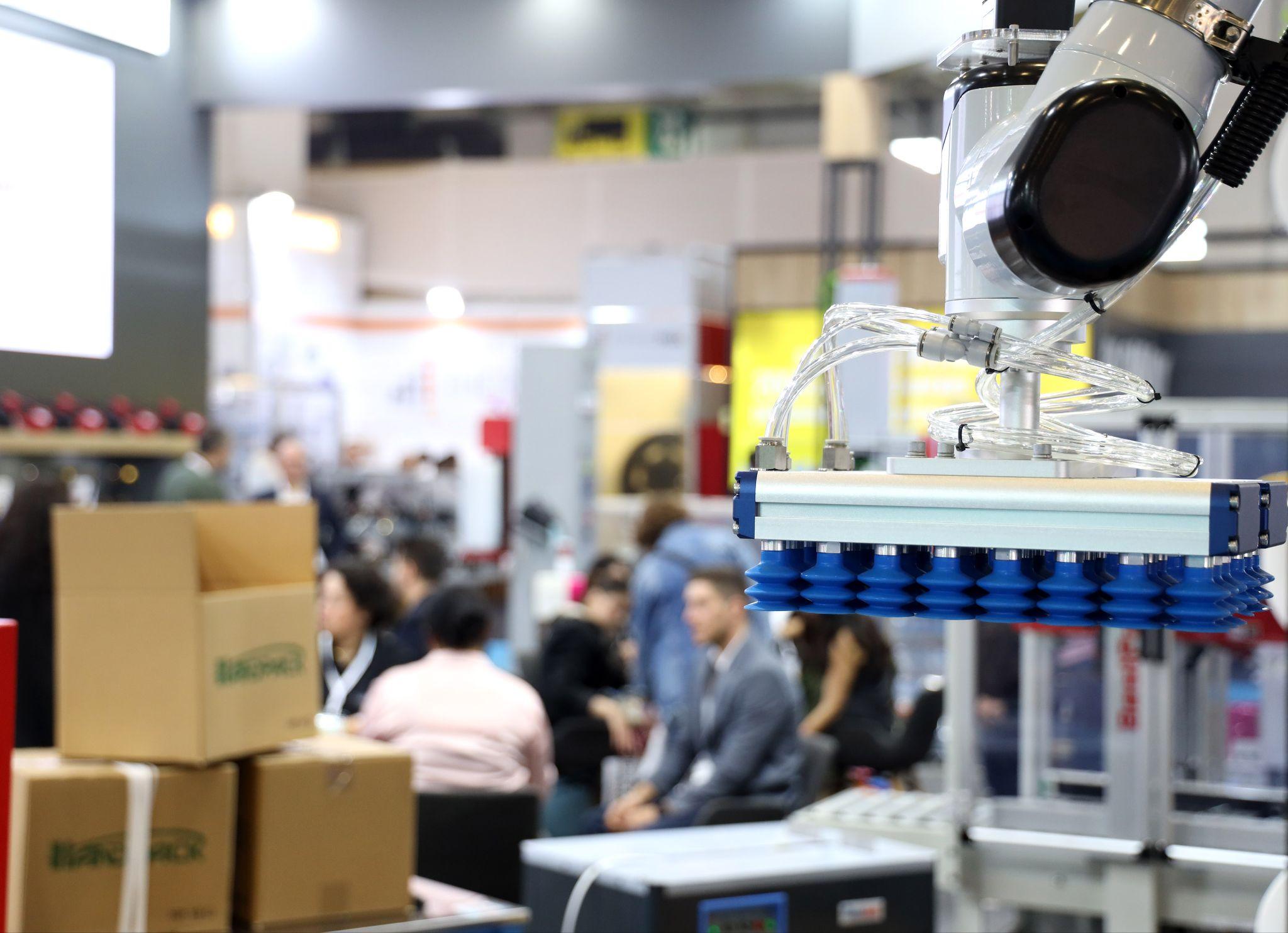 Industry buyers worldwide will convene at Eurasia Packaging Istanbul in October 2026: a robotic vacuum gripper lifting cartons on an exhibitor stand at Eurasia Packaging Istanbul