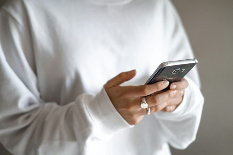 Money worries need not mean panic spending: plan budgets and repayments Money worries need not mean panic spending: plan budgets and repayments: a person in a white jumper checking their household budget on a mobile phone